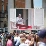 The pope is speaking to a large crowd.